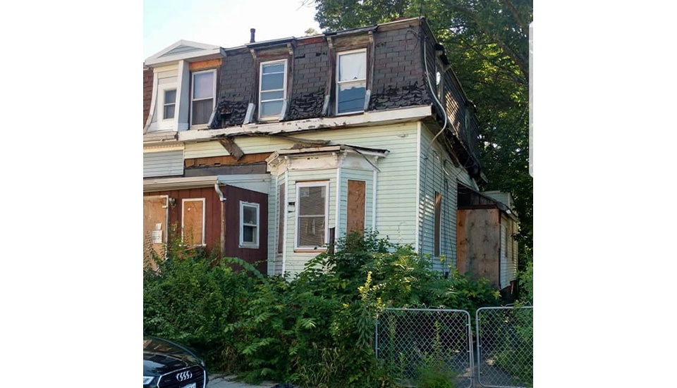 before image of a house exterior with dilapidated roof and siding
