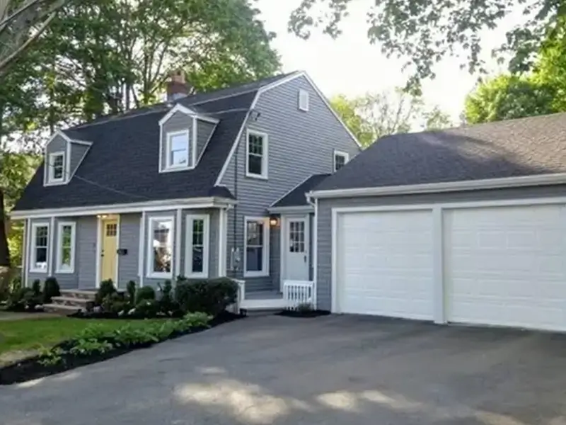 New England home and garage with fresh exterior painting